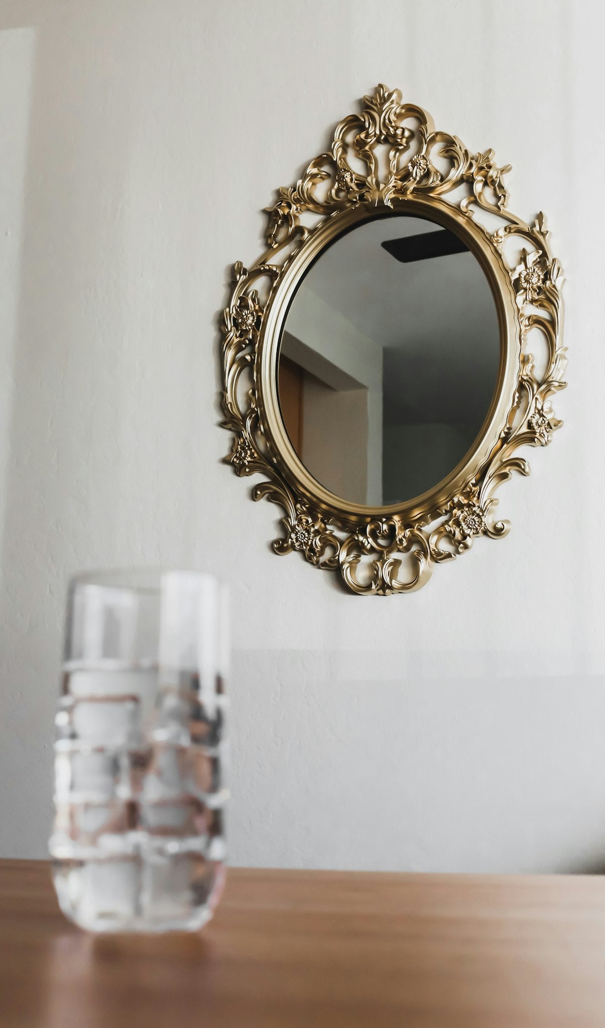 Round gold frame wall mirror, styled view